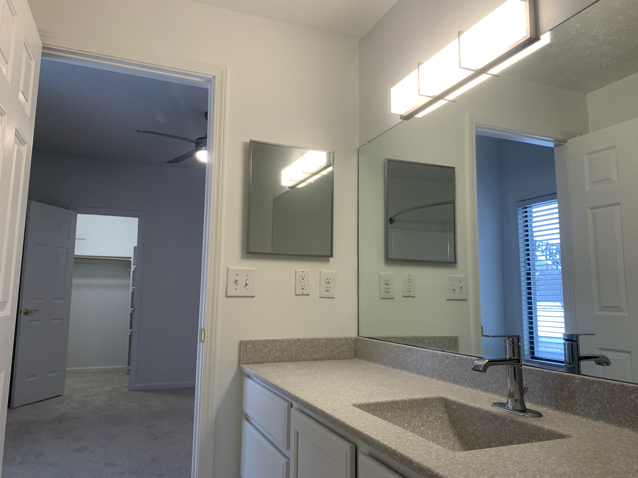 an empty bathroom with a sink and a mirror