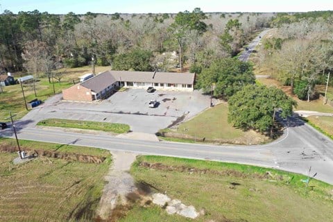 an aerial view of a building and a parking lot