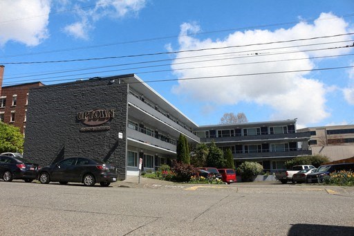 a large building with cars parked in front of it