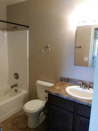 a bathroom with a toilet and a sink and a shower