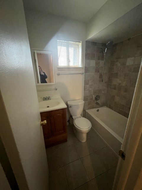 A bathroom with a toilet, sink, and bathtub.