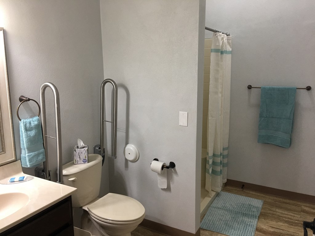 a small bathroom with a shower toilet and sink