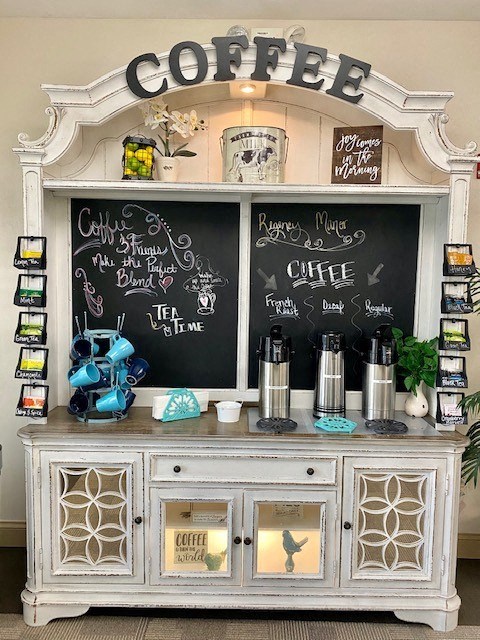 a coffee bar with a chalkboard menu on it