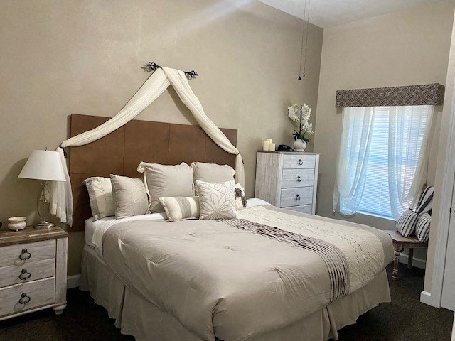 a bedroom with a large bed with pillows