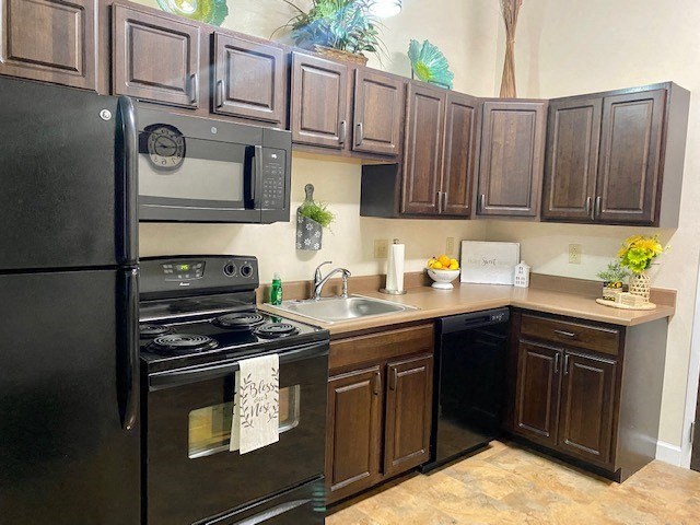 a kitchen with black appliances and brown cabinets