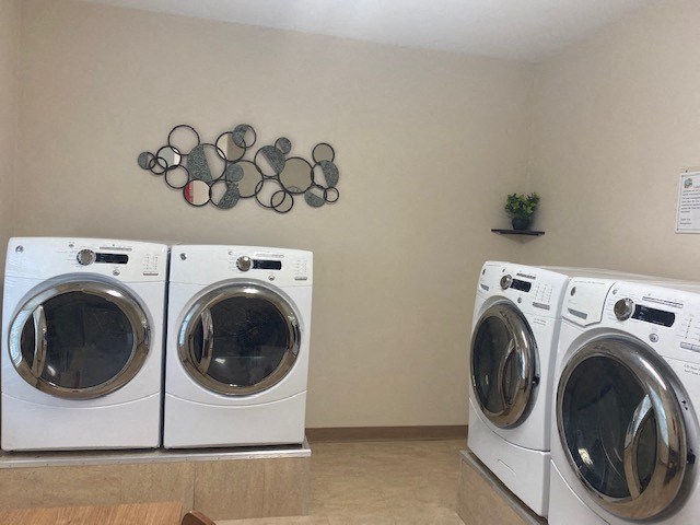 a laundry room with two washes and a dryer