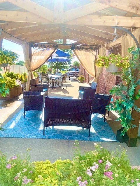 a patio with a table and chairs under a canopy