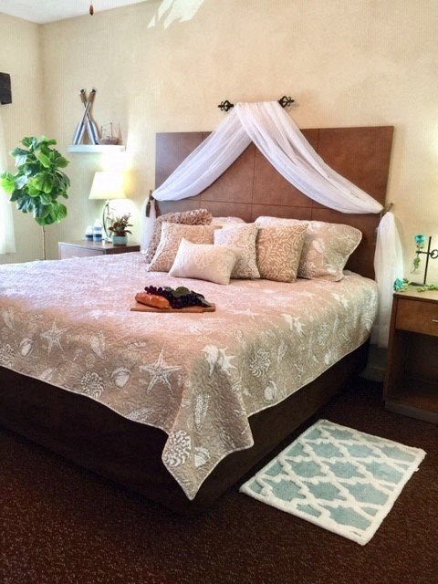 a bed with a canopy and pillows on it