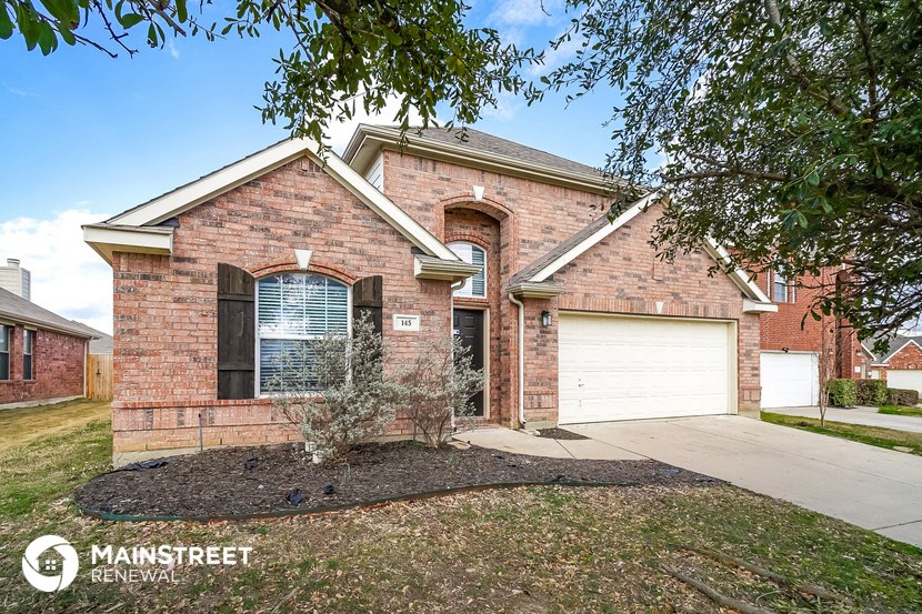 a brick house with a white garage door