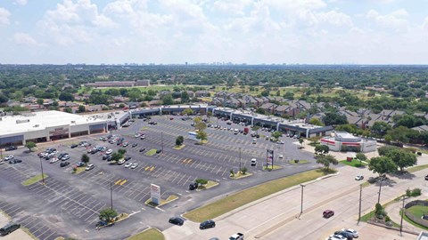 an aerial view of the parking lot of a shopping center