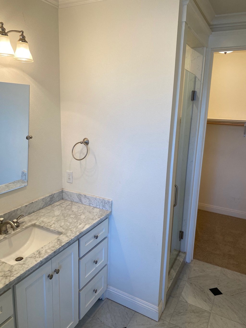 an empty bathroom with a sink and a mirror