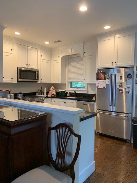 a kitchen with a island and stainless steel appliances