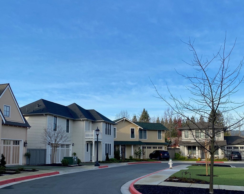 a row of houses on the corner of a street