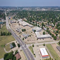 an aerial view of a city with a highway and buildings