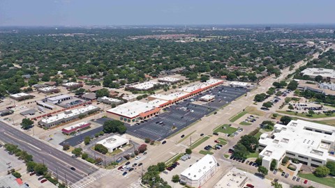 an aerial view of a parking lot and buildings in a city