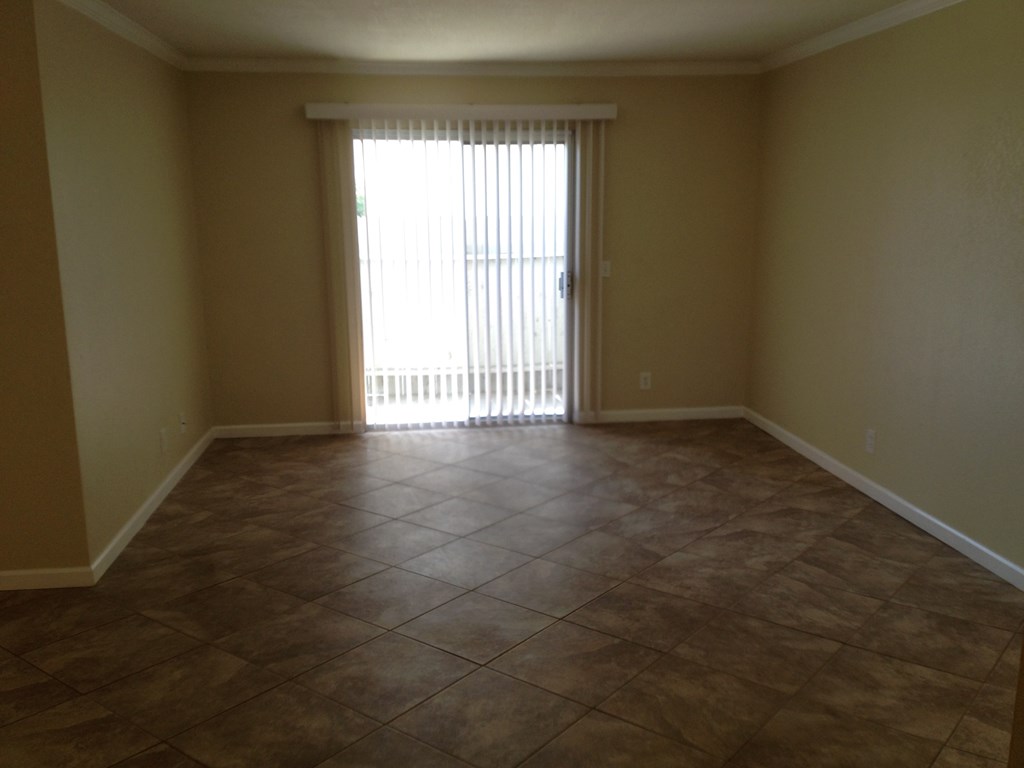 an empty living room with a sliding glass door