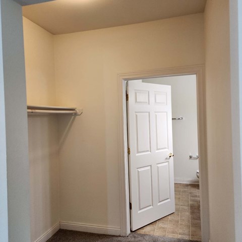 A white door is open to a hallway.