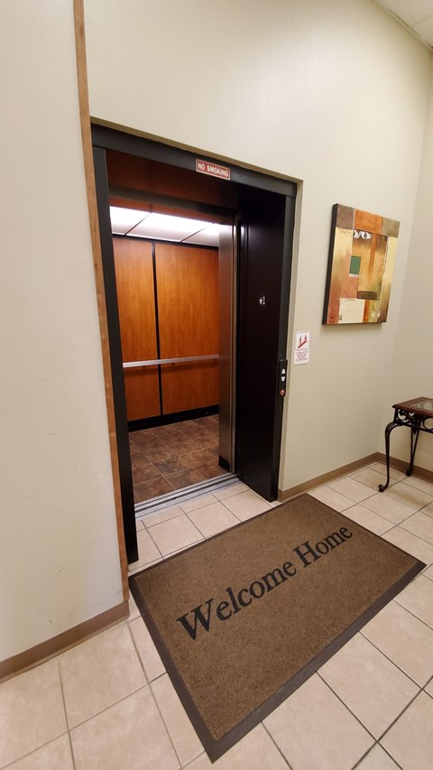 A brown mat on the floor with the words Welcome Home on it.