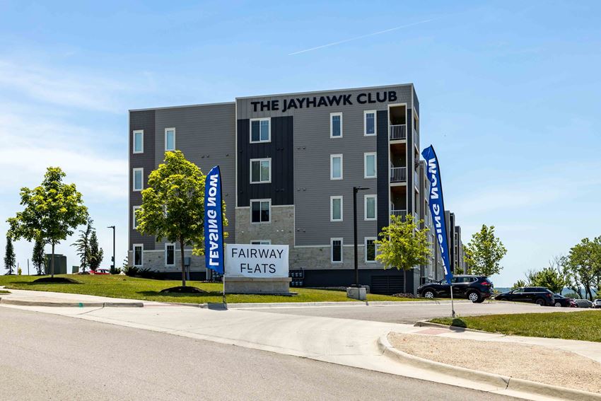 Exterior View of The Fairways Apartments Mid-Rise Building with Lush Landscaping and Ample Parking - Photo Gallery 1