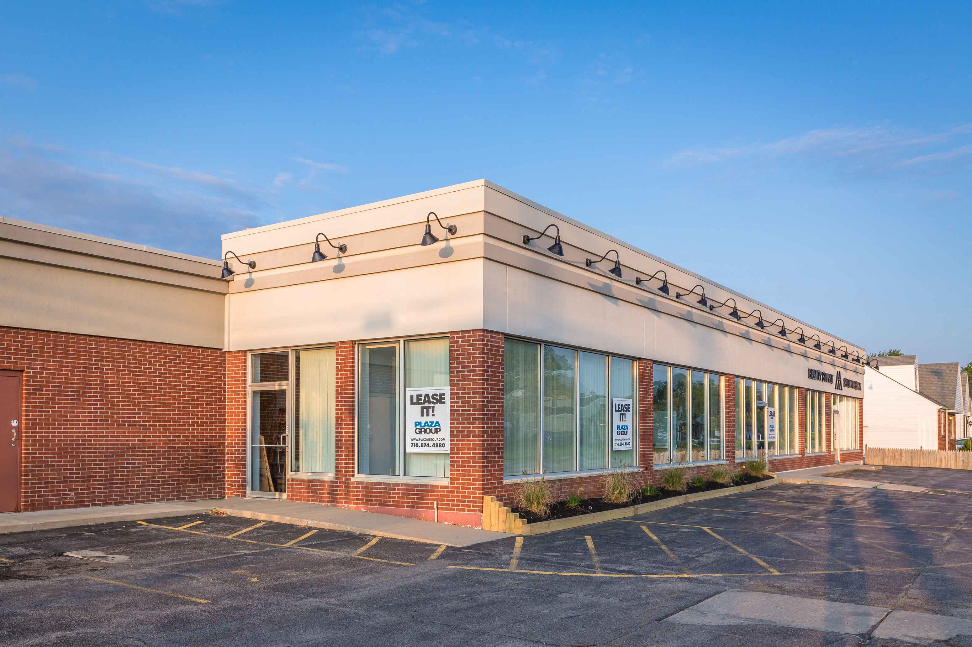 A building with a "LEASE IT" sign on the window.