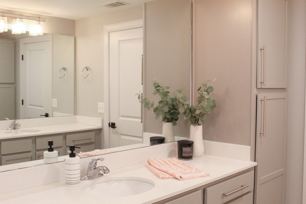 a white bathroom with two sinks and a mirror