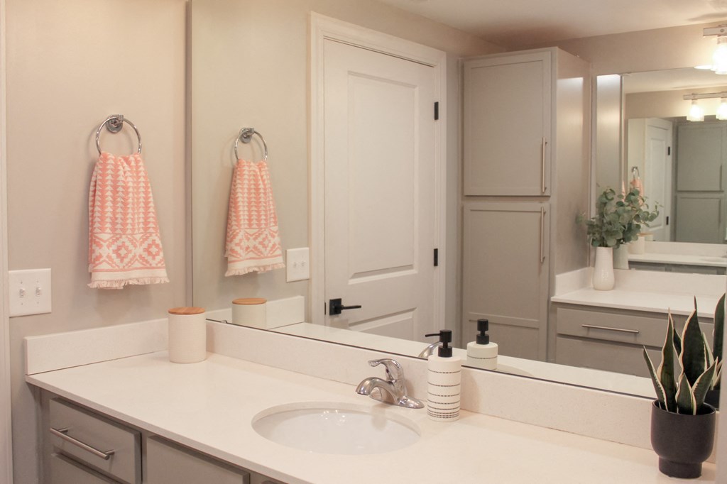 a white bathroom with a sink and a mirror