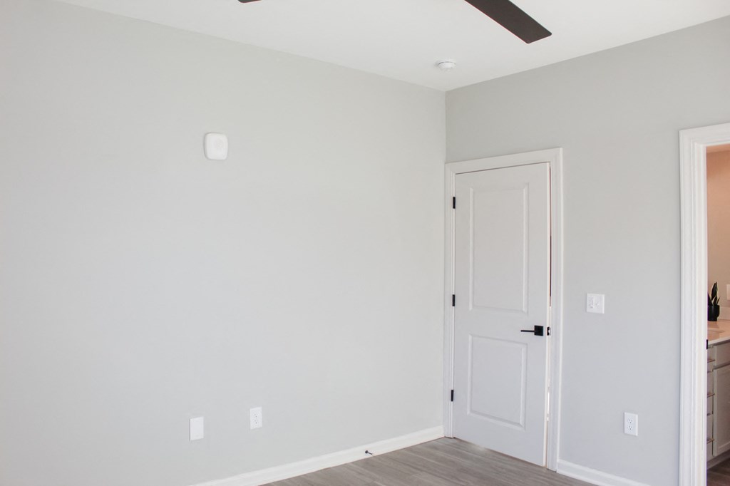 an empty room with a white door and a white wall