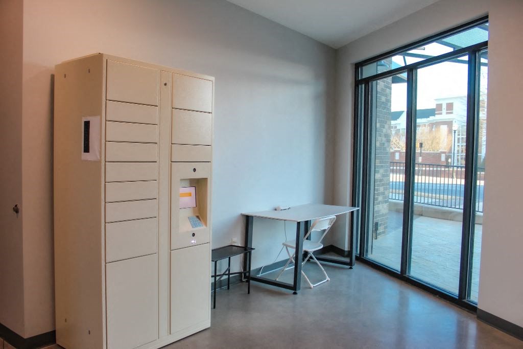 a room with a desk and a filing cabinet and a window