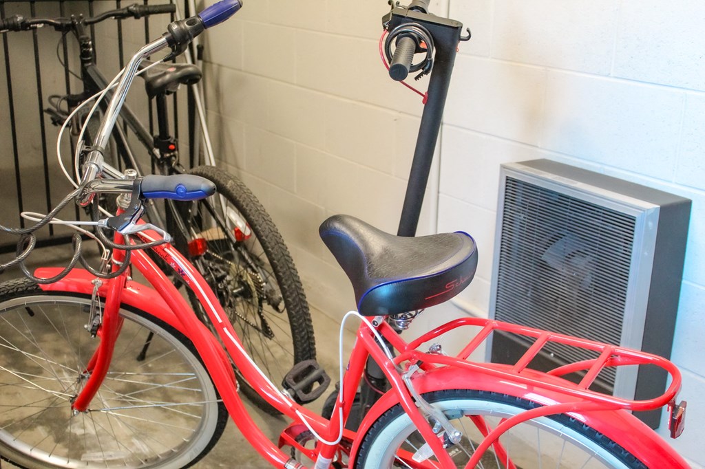 two bikes parked next to each other in front of a wall