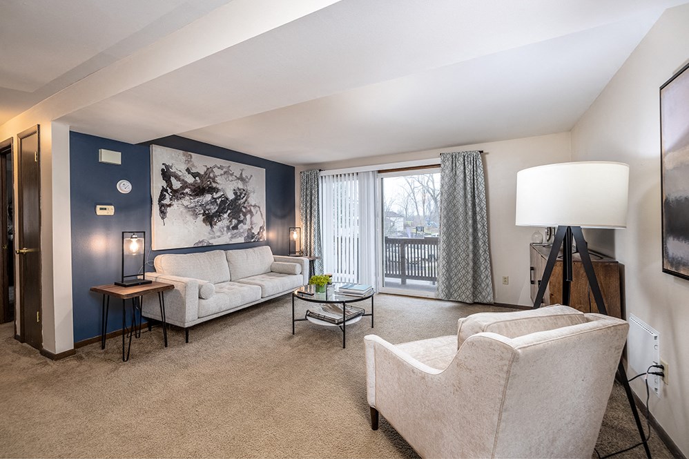 a living room with a couch and a chair and a table