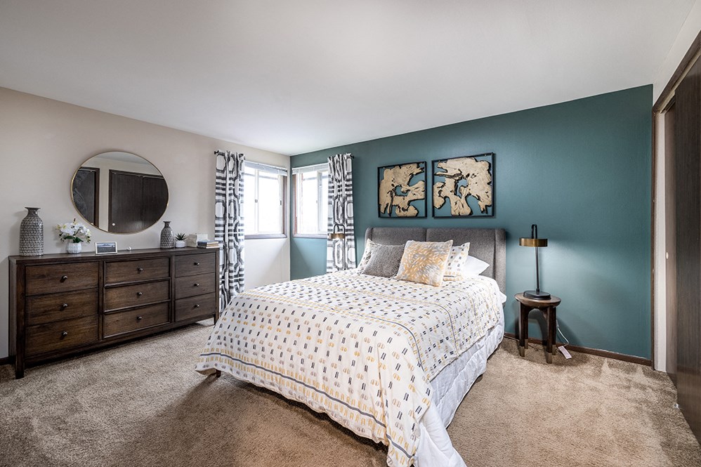 a bedroom with a bed and a dresser