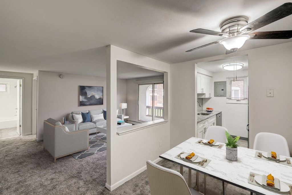 a living room and dining room with a table and chairs