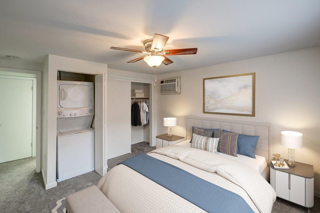 a bedroom with a bed and a ceiling fan
