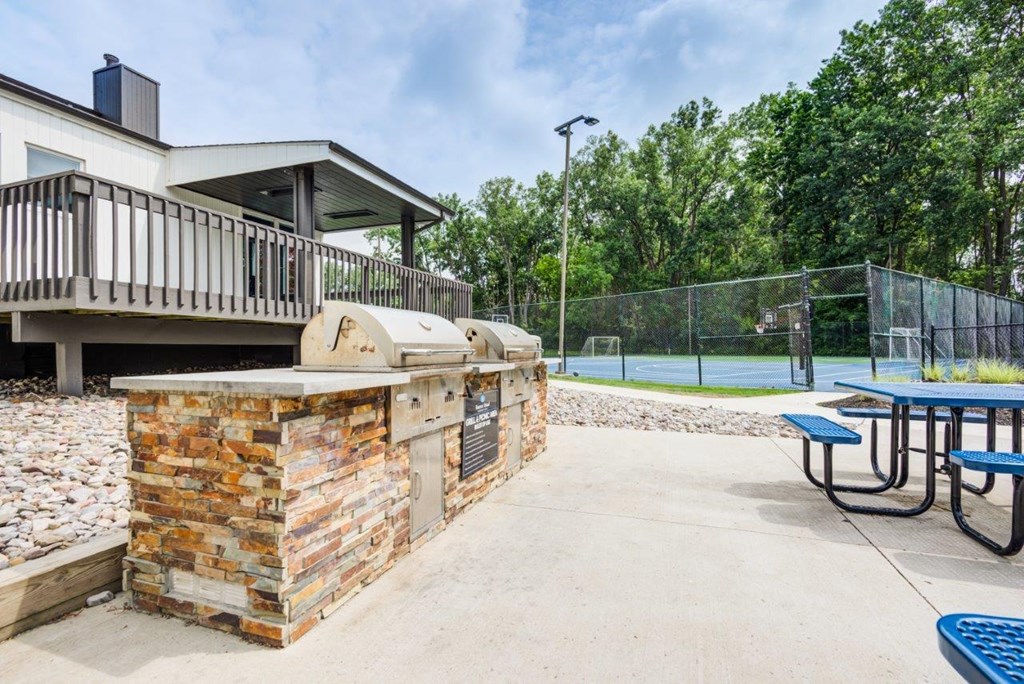 the pavilion with picnic tables and a basketball court