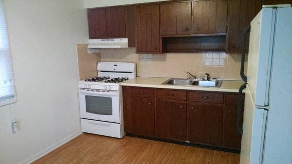 a kitchen with a stove and a sink and a refrigerator