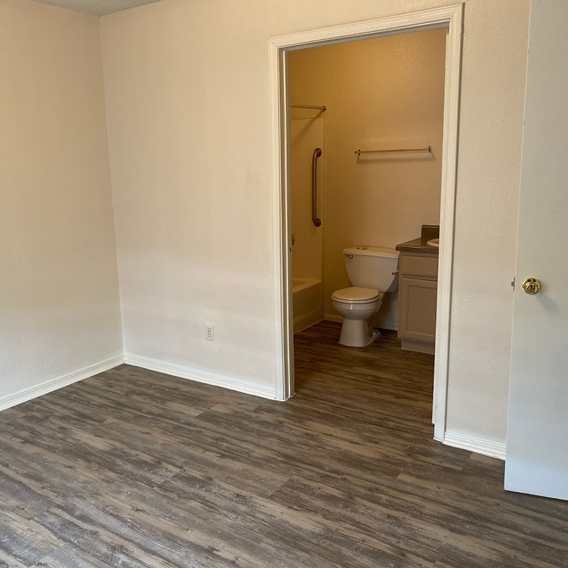 A bathroom with a toilet and a shower.