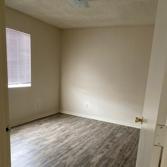 A room with a window and a door.