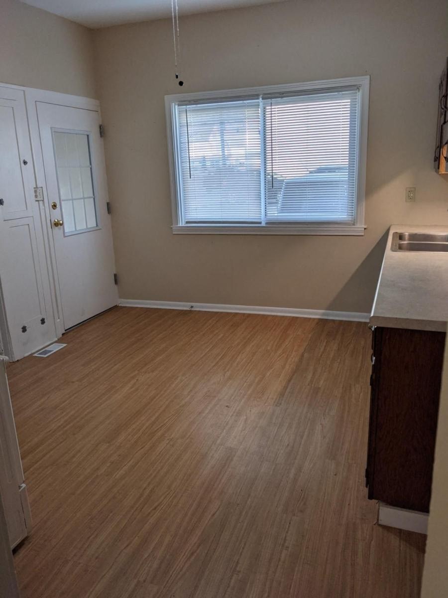 an empty kitchen and living room with a window