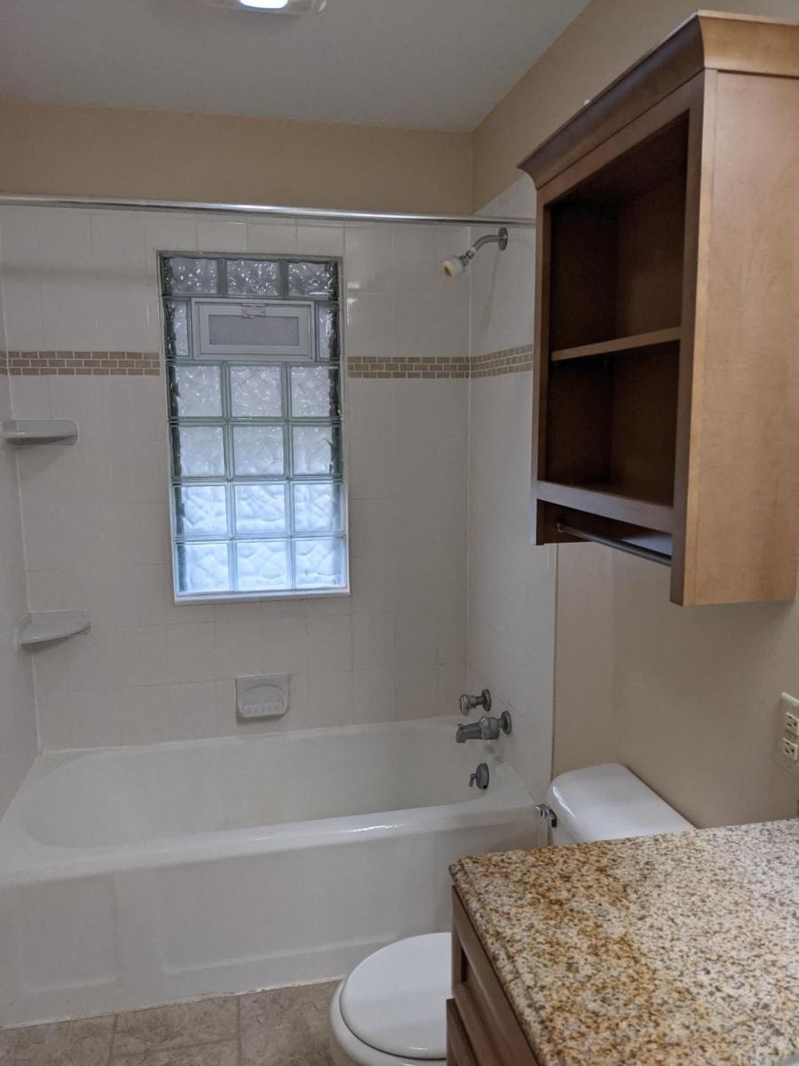 a bathroom with a tub and a toilet and a sink