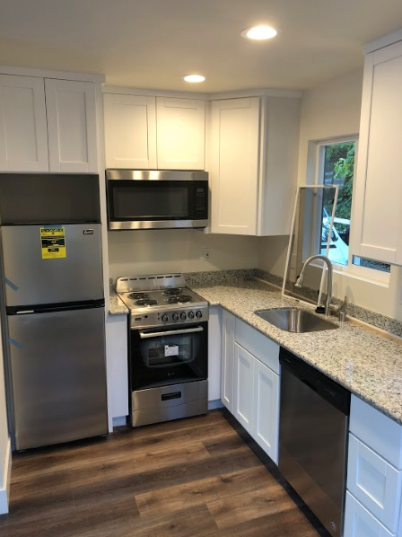 A kitchen with a stainless steel refrigerator and a stainless steel oven.