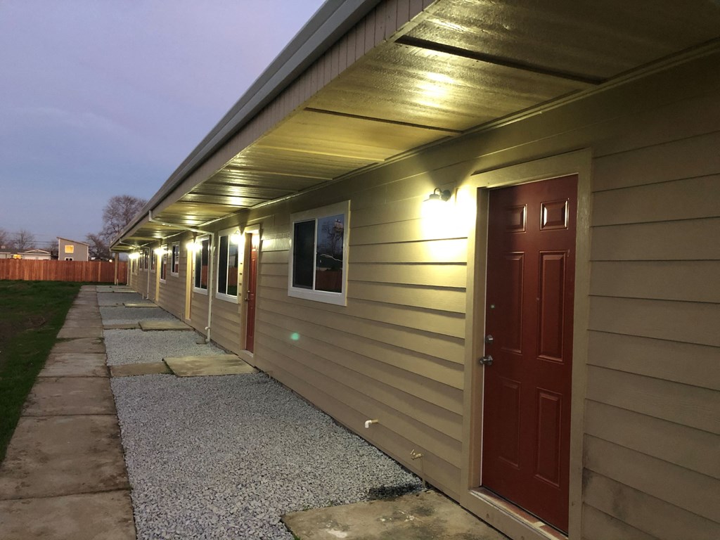 a side view of a house with a red door