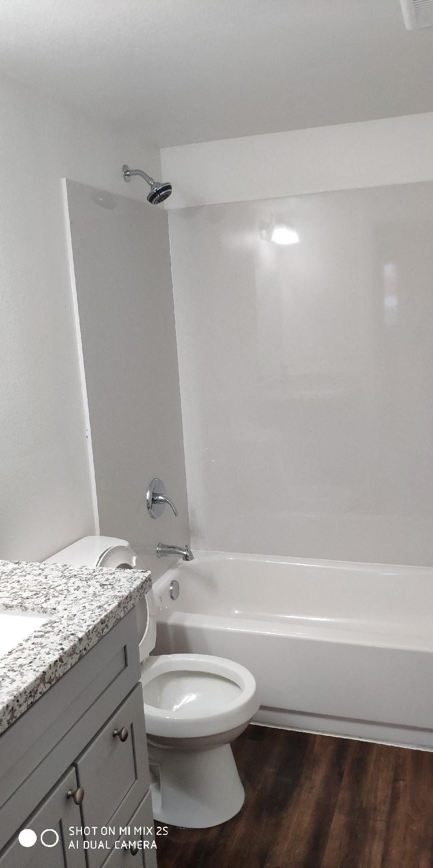 a bathroom with a toilet and a tub and a sink