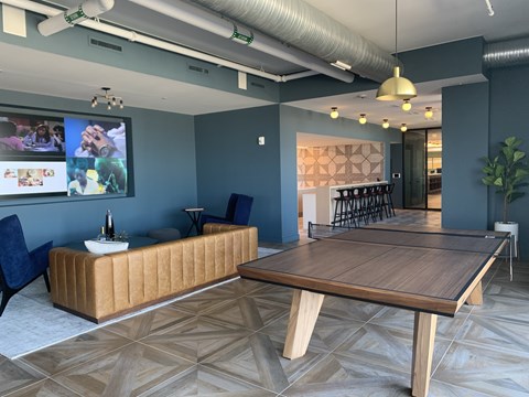 A conference room with a long table and a sofa.