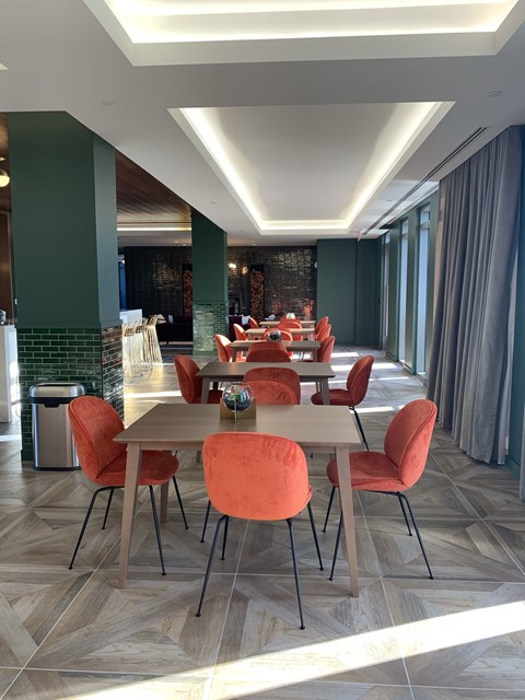A dining room with a long table and chairs.