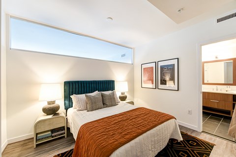 a bedroom with a large bed and a window