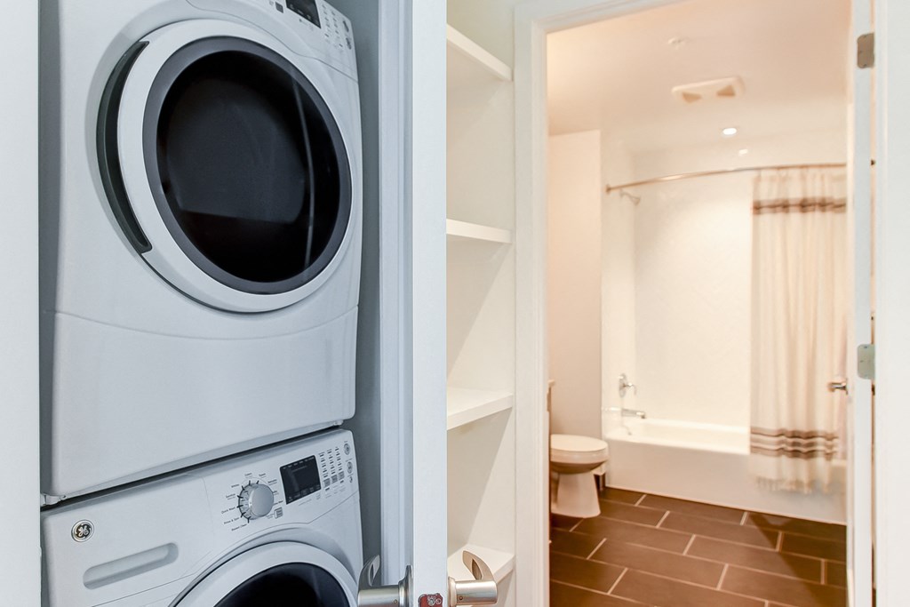 a washing machine in a bathroom and a washer and dryer in a closet