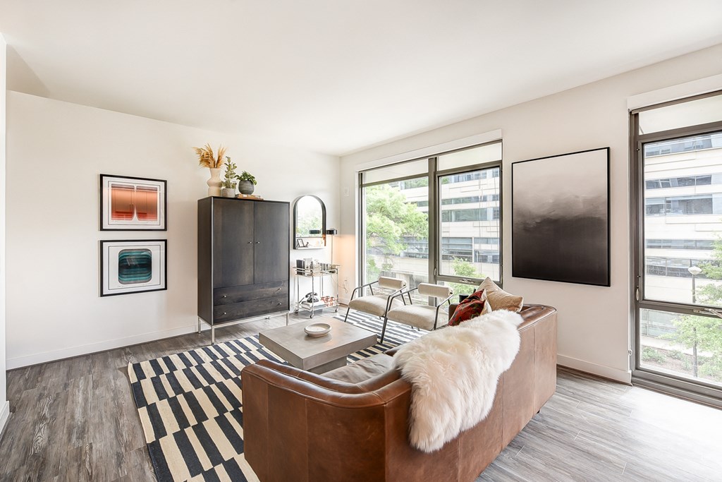 a living room with a leather couch and a television