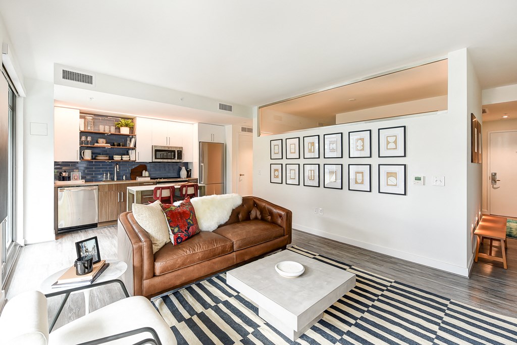 a living room with a leather couch and a coffee table