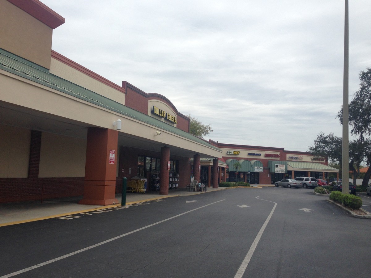 A parking lot in front of a store with a sign that says "Holiday Inn".