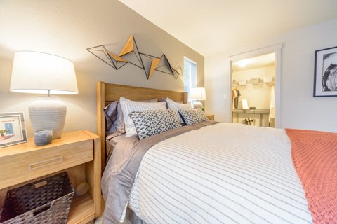 a bedroom with a large bed and a mirror